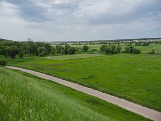 Abandoned football field in the countryside, among fields and forests, on a summer day.
