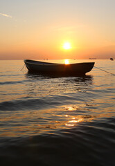 lonely boat in the sea at sunset