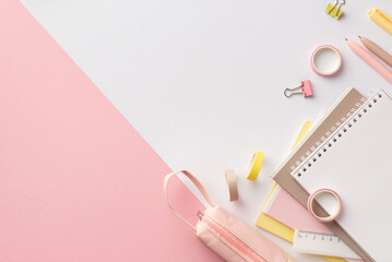School supplies concept. Top view photo of stationery note pads pens ruler binder clip adhesive tape and pencil-case on bicolor pink and white background with copyspace