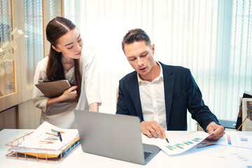 Portrait of Young businessman and female secretary meeting in the office. Business success concept.