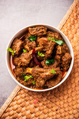 Sukha mutton or chicken, dry spicy Murgh or goat meat served in a plate or bowl