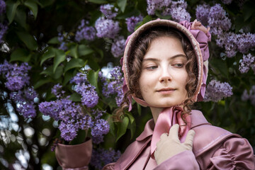 Obraz premium Young woman in historical dress. Fashionable clothes of the 19th century. Historical women's costume.