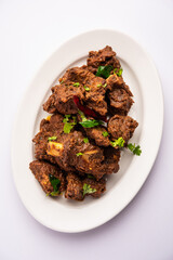 Sukha mutton or chicken, dry spicy Murgh or goat meat served in a plate or bowl