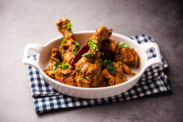 Sukha mutton or chicken, dry spicy Murgh or goat meat served in a plate or bowl