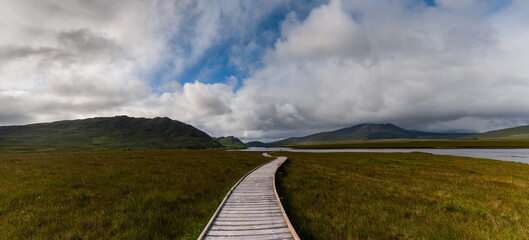 panorama landscape of the Claggan Mountain Coastal Trail bog and boardwalk with the Nephir mountain...