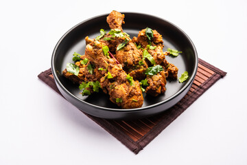 Sukha mutton or chicken, dry spicy Murgh or goat meat served in a plate or bowl