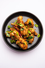 Sukha mutton or chicken, dry spicy Murgh or goat meat served in a plate or bowl