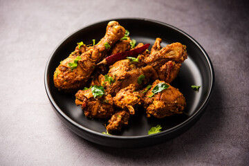 Sukha mutton or chicken, dry spicy Murgh or goat meat served in a plate or bowl