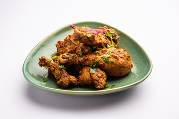 Sukha mutton or chicken, dry spicy Murgh or goat meat served in a plate or bowl