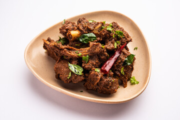 Sukha mutton or chicken, dry spicy Murgh or goat meat served in a plate or bowl