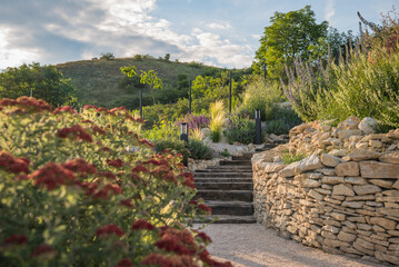 Rustic wooden stairs and stone wall in the garden.