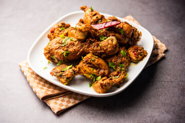 Sukha mutton or chicken, dry spicy Murgh or goat meat served in a plate or bowl