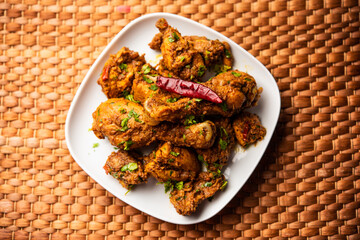 Sukha mutton or chicken, dry spicy Murgh or goat meat served in a plate or bowl