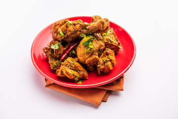 Sukha mutton or chicken, dry spicy Murgh or goat meat served in a plate or bowl