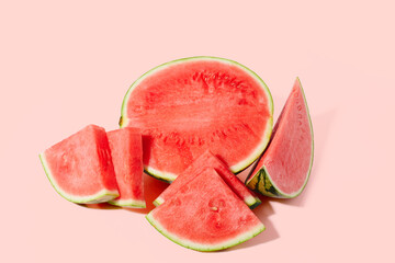 Cut watermelon on red pastel background