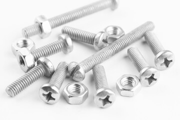 Group of screw-bolts isolated on white. Standing out of the crowd concept.