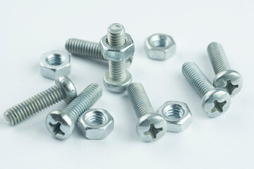 Group of screw-bolts isolated on white. Standing out of the crowd concept.