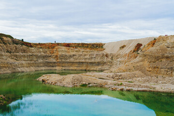 Lake formation in an old abandoned quarry. Quarry lake. Termination of mining operations.