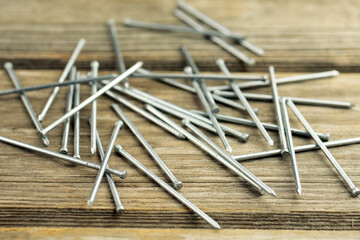 Close-up of long nails, on a gray background. Building a house. A poster for a building materials store or catalog.