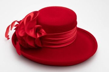 Studio photo of a red vintage hat. The background is white.