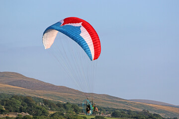 Paramotor pilot in the hills of Wales	