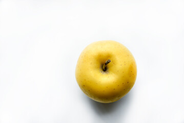 Yellow sweet apple on a white background