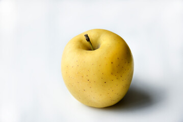 Yellow sweet apple on a white background