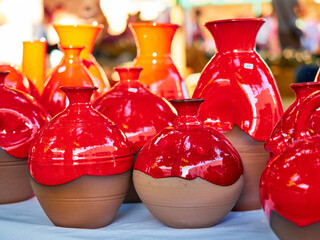 Different handmade ceramic pots for sale painted in red color