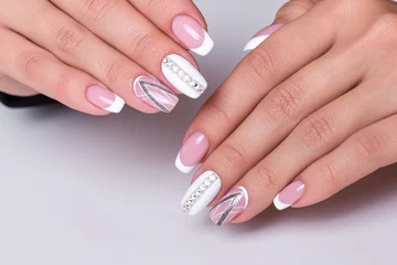   Beautiful female hands with wedding manicure nails with ring on white background © Galina