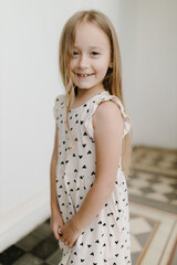  Portrait of a little smiling girl on a gray background