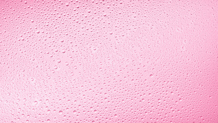 Medium size water drops on the wet glass surface on pink background | Background for skin care moisturizing products