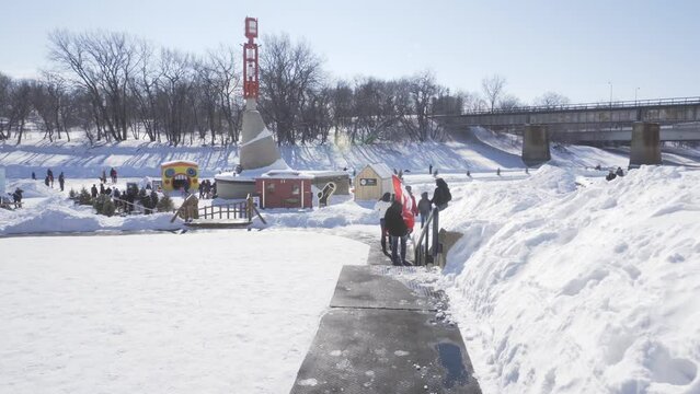 Winnipeg, Manitoba - Canada - February 27, 2022: Walking Along Frozen Assiniboine River in Winnipeg.