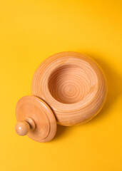 wooden bathhouse on a yellow background. sugar bowl made of wood