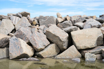 rocks on the beach, a wall of stones 
