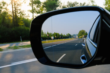look in the rear view mirror of a car