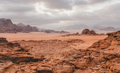 Red orange Mars like landscape in Jordan Wadi Rum desert, mountains background, overcast morning. This location was used as set for many science fiction movies