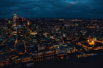 Fotobehang Aerial view of north London, blue hour just after sunset. Famous Tower visible in bottom right corner near river Thames. Orange yellow street lights starting to glow © Lubo Ivanko
