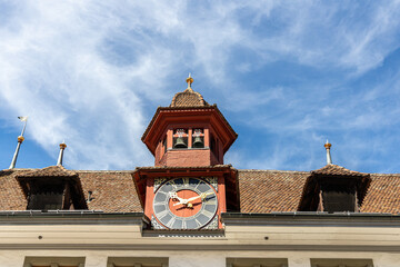 roof of the building with a clocktower under cloudy sky