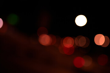 orange bokeh light circles on black background