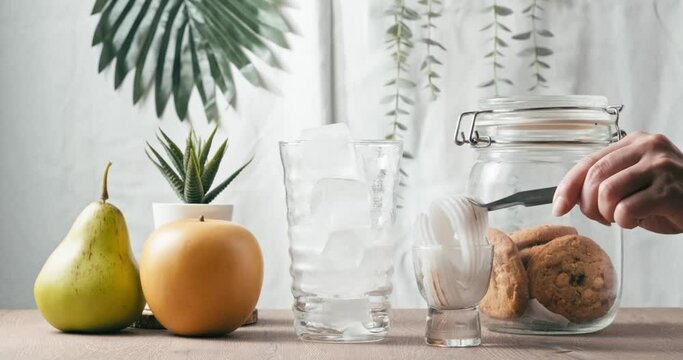 4k video, Fresh sweet coconut fruit juice for health care drinking in home. used hand take coconut meat fruit into cup with coconut drink in glass with summer on white background