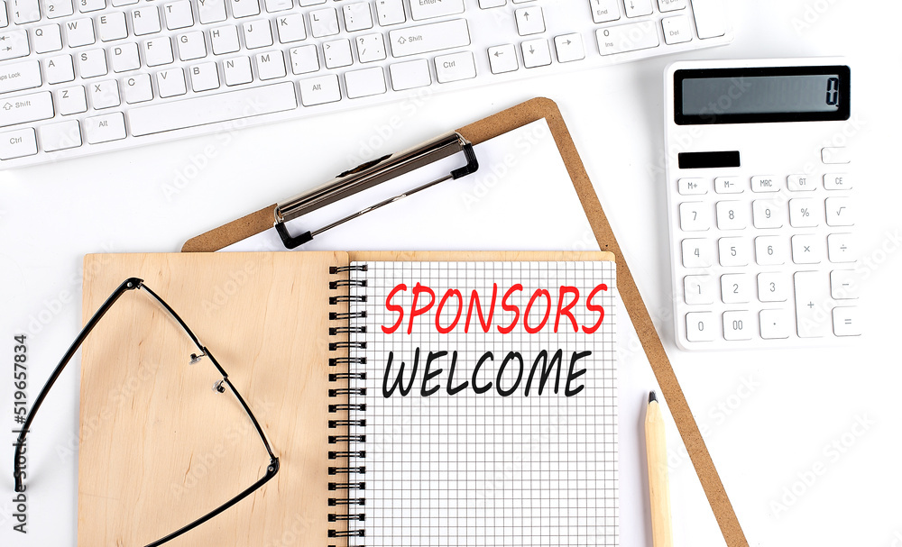 Poster notebook with the word sponsors welcome with keyboard and calculator on the white background