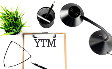 YTM - Yield To Maturity text on a clipboard on the white background