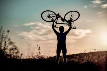 cyclist silhoutte with bicycle raised to sky race and victory concept