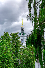 Kostroma Church of the Savior in rows among the trees. Orthodox church in the old shopping malls in the style of classicism of the XVIII century. Kostroma, Russia, 2022