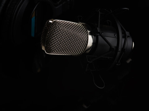 studio microphone on a black background. Minimalism. Close-up. Singing, concert, rehearsal, speaker. Night club, radio, performance. There are no people in the photo. Advertising, banner.