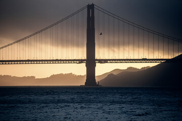 Golden Gate bridge at sunset on a cloudy day