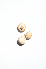 Raw mushrooms champignons, isolated on a white background with copy space for advertising text or web banner. Flat lay.