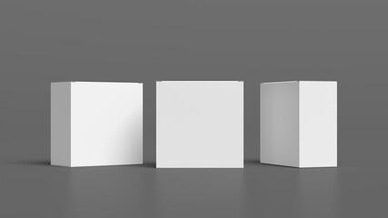 Three square boxes mock up. White gift boxes on gray background. Front view.
