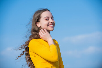 teen girl with smiling face on sky background.