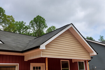 The new house was covered with a modern asphalt shingle roof in construction site